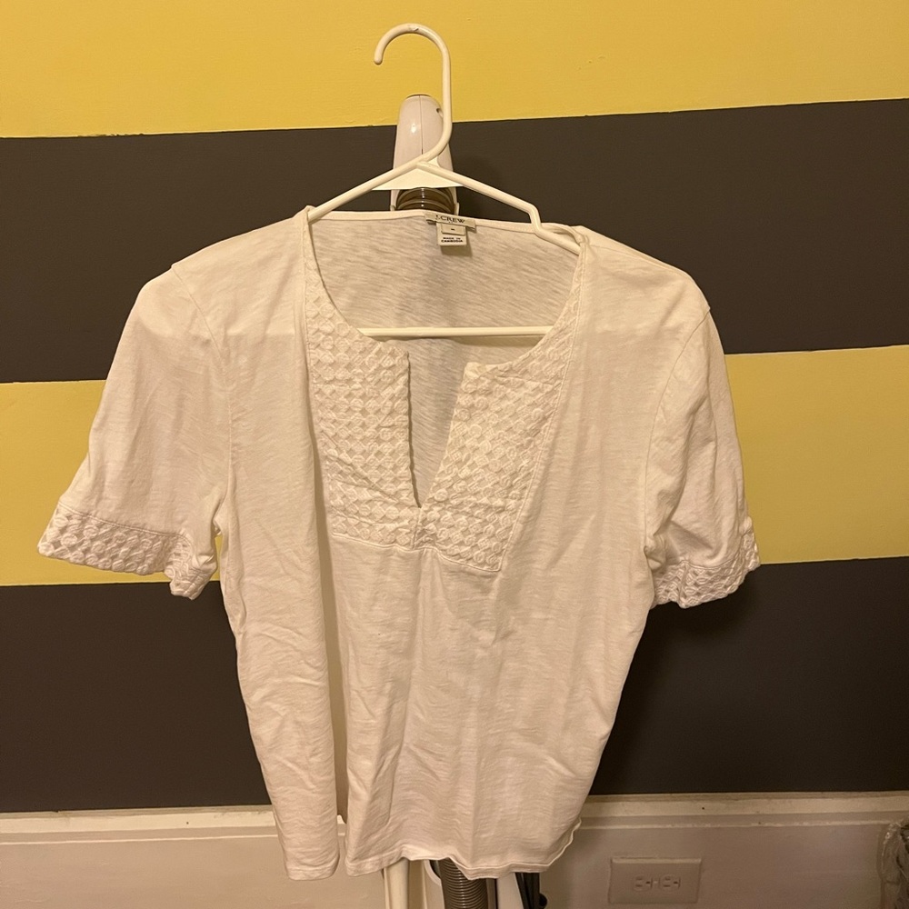 White shirt, with detailing on the front and sleeves